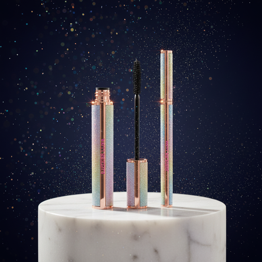 Luna Luxe Mascara and Eyeliner Duo - improved hero shot on marble pedestal with holographic glitter tubes backlit against midnight navy backdrop